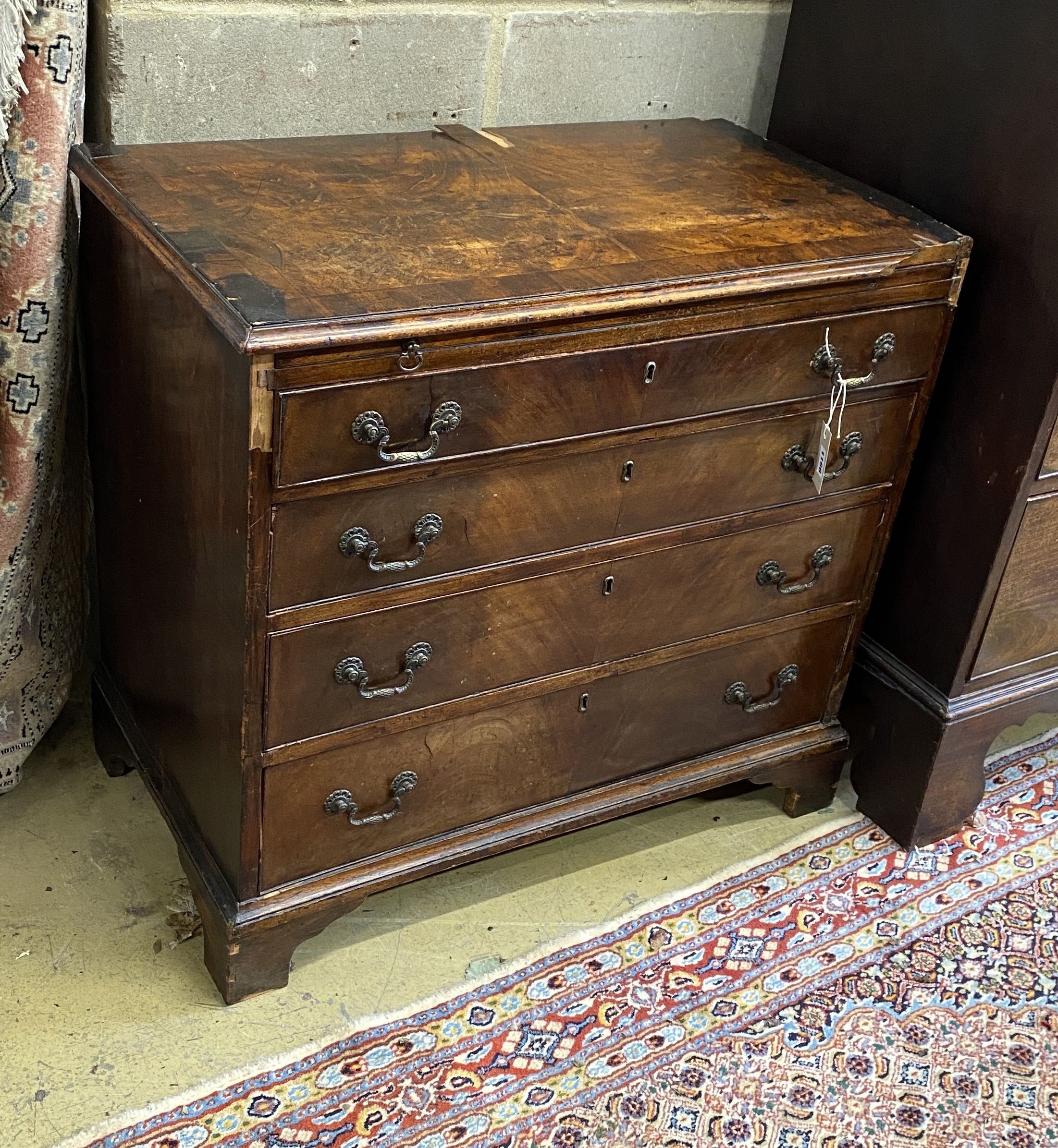 A small George III provincial mahogany four drawer chest with brushing slide, in need of restoration, width 83cm, depth 47cm, height 78cm